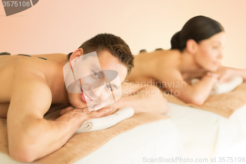 Image of couple in spa with hot stones