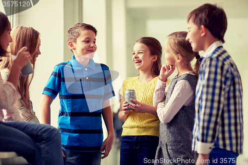 Image of group of school kids with soda cans in corridor