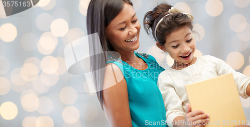 Image of happy mother and child with gift box