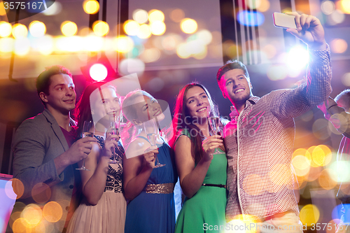 Image of friends with glasses and smartphone in club