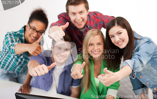 Image of group of happy students showing thumbs up