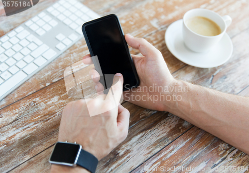 Image of close up of hands with smart phone and watch