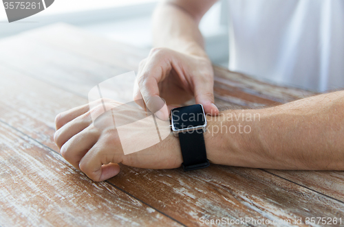 Image of close up of male hands setting smart watch