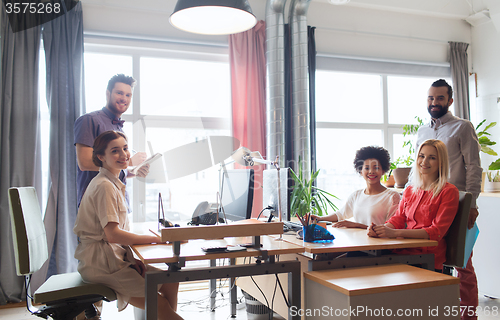 Image of happy creative team in office