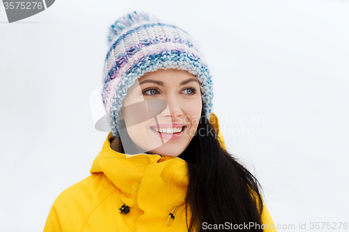 Image of happy young woman in winter clothes outdoors