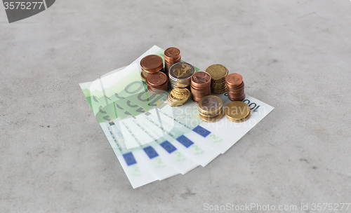 Image of close up of euro paper money and coins on table