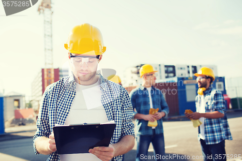 Image of group of builders in hardhats outdoors