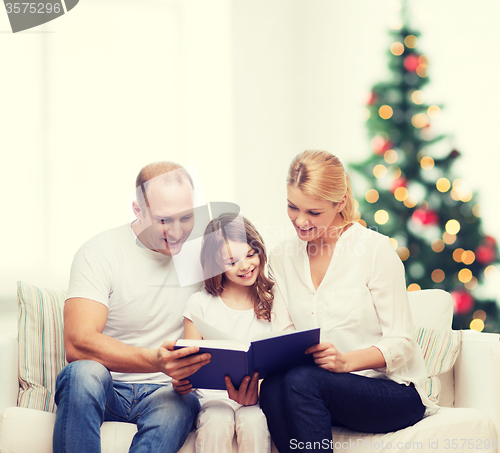 Image of happy family with book at home