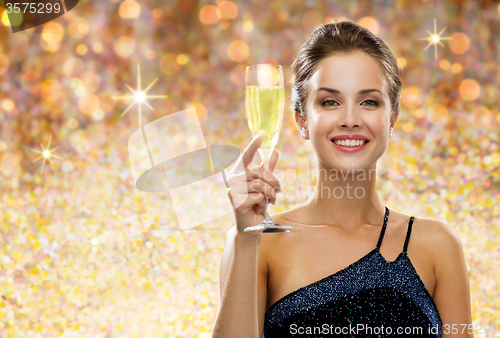 Image of smiling woman holding glass of champagne