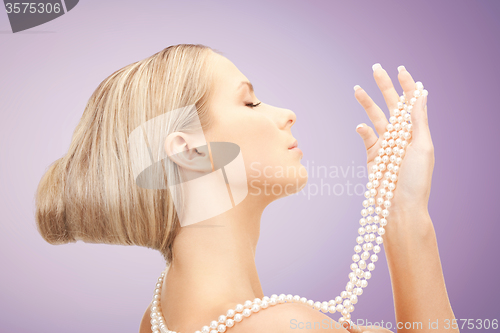 Image of beautiful woman with pearl necklace over violet