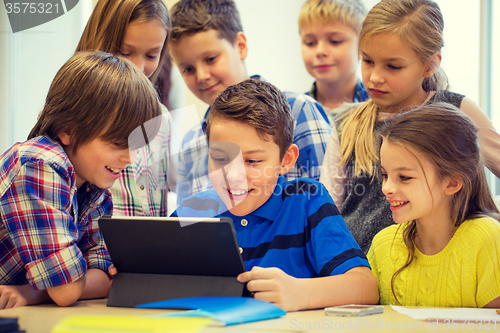 Image of group of school kids with tablet pc in classroom