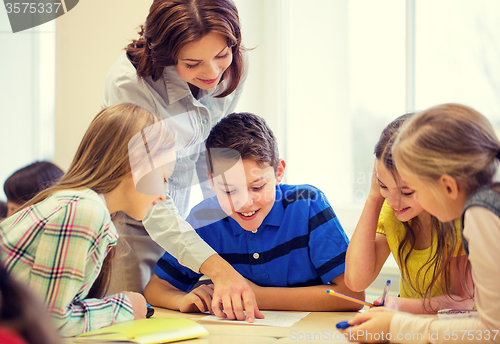 Image of group of school kids writing test in classroom