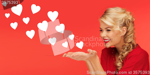 Image of woman sending heart shapes from palms of her hands