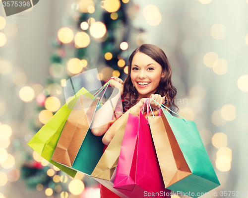 Image of smiling woman with colorful shopping bags