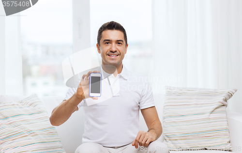 Image of happy man with smartphone at home