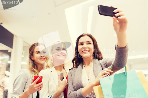 Image of women with smartphones shopping and taking selfie