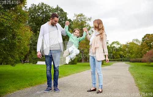 Image of happy family walking in summer park and having fun