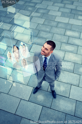 Image of young smiling businessman outdoors from top