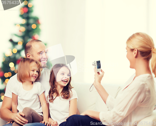 Image of happy family with camera at home