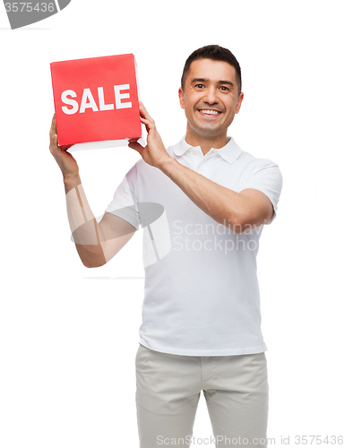 Image of smiling man with red sale sigh