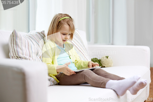 Image of little girl with tablet computer at home