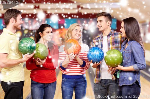 Image of happy friends in bowling club at winter season