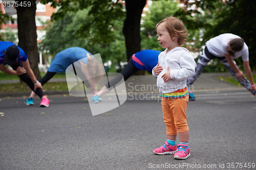 Image of jogging people group have fun with baby girl