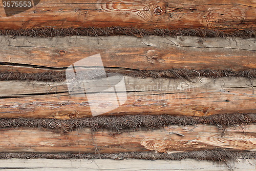 Image of wall of the old logs caulking hemp