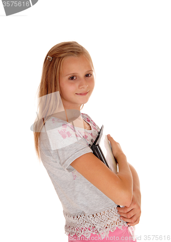 Image of Schoolgirl holding her books to her chest.