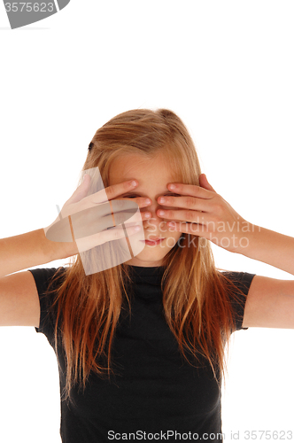 Image of Blond girl holding her hands over eye\'s. 