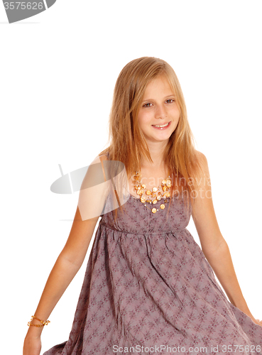 Image of Lovely little girl sitting on floor.