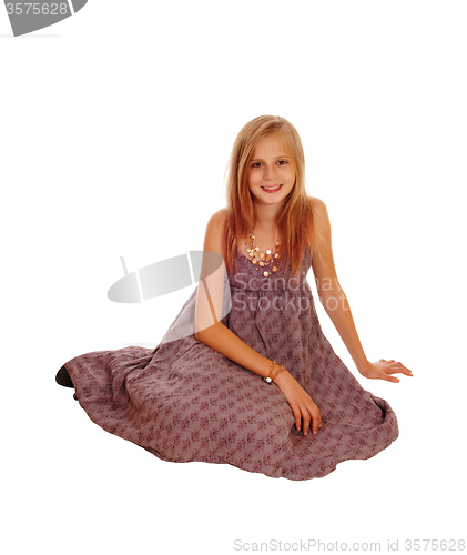 Image of Beautiful little girl sitting on floor.
