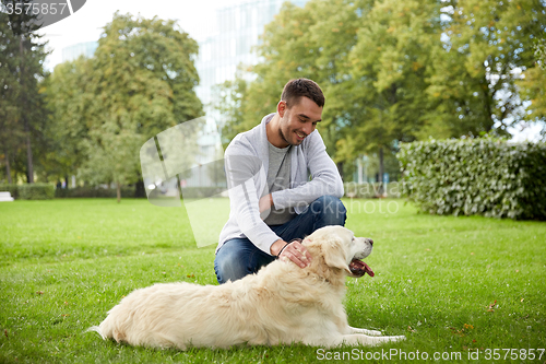 Image of happy man with labrador dog walking in city