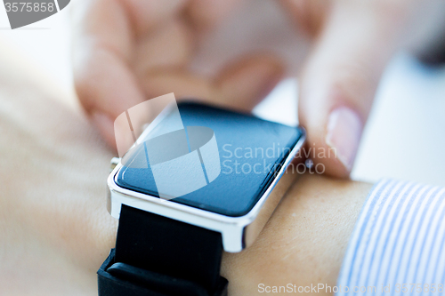 Image of close up of hands setting smart watch