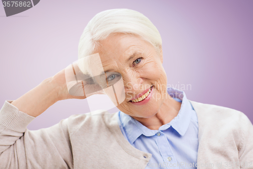 Image of happy senior woman face over violet background