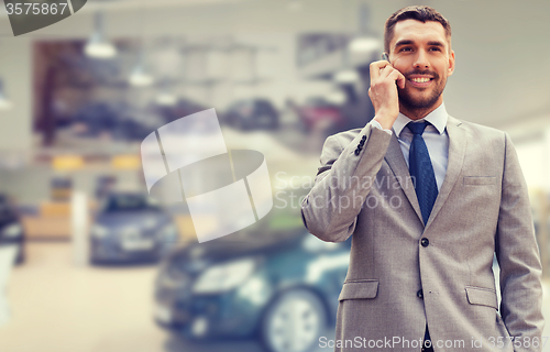 Image of smiling businessman talking on smartphone