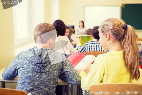 Image of group of school kids writing test in classroom