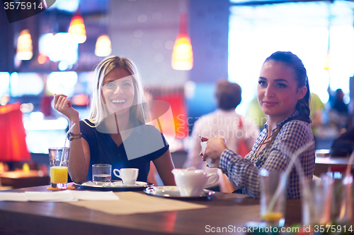 Image of girls have cup of coffee in restaurant