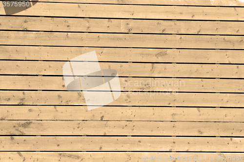 Image of sepia wall in old construction nail and house