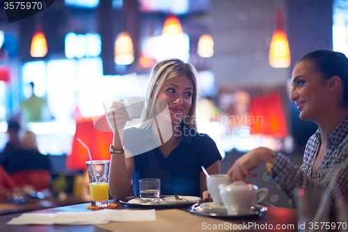 Image of girls have cup of coffee in restaurant