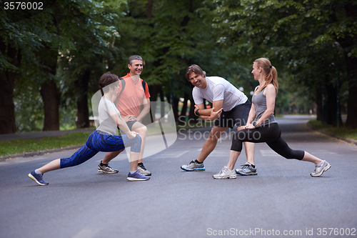 Image of jogging people group stretching