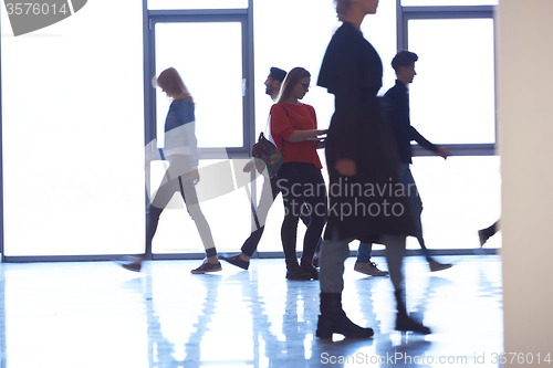 Image of student girl standing with laptop, people group passing by