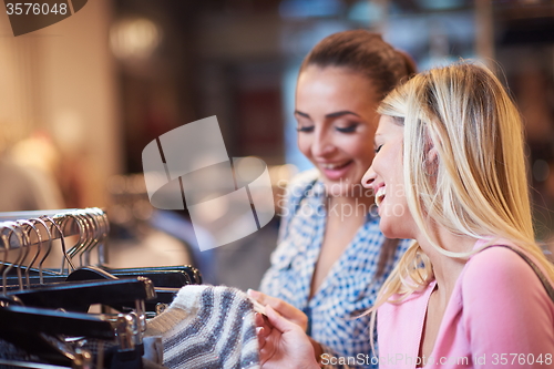 Image of happy young girls in  shopping mall