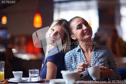 Image of girls have cup of coffee in restaurant