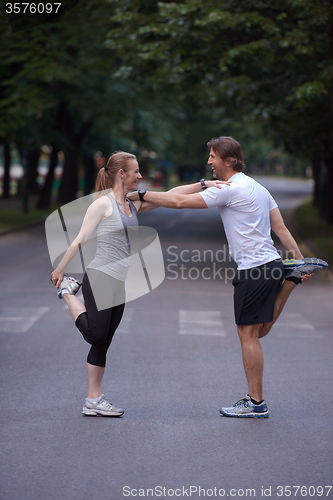 Image of jogging couple stretching