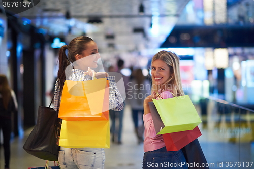 Image of happy young girls in  shopping mall