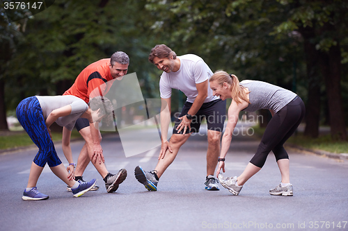 Image of jogging people group stretching