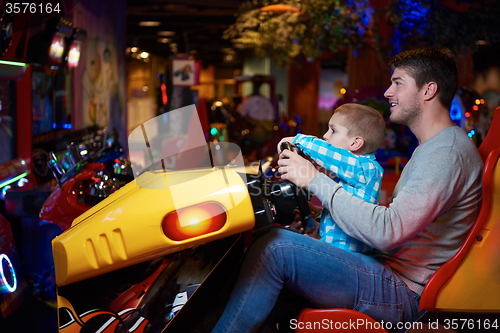 Image of father and son playing game in playground