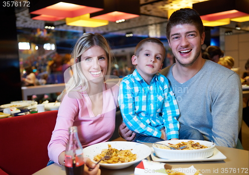 Image of family having lunch in shopping mall