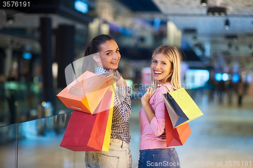 Image of happy young girls in  shopping mall